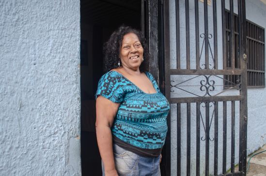Norys Orozco standing in front of her home in the San Blas barrio, Photograph by Stephanie Marcelot.