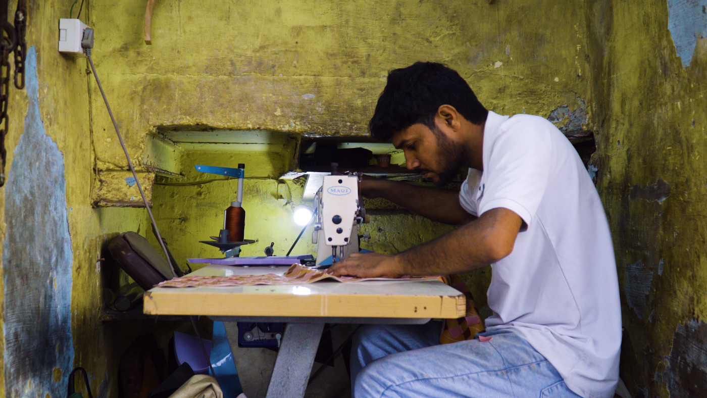 Nanu at work in his tiny workshop