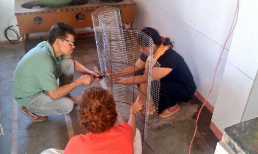 Ataide, Aditi and Marcella working on a ferrocement structure to cover an open drain.
