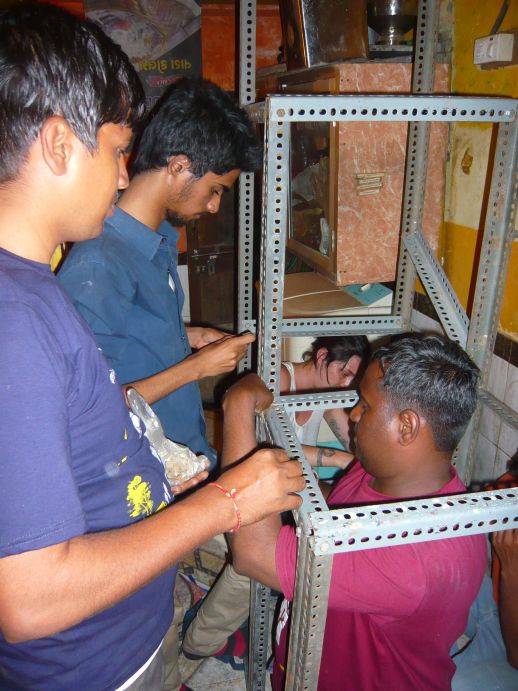 Shambhu, Prateek, Cecilia and Shenu working on a staircase/shelves for a small home in Shivaji Nagar