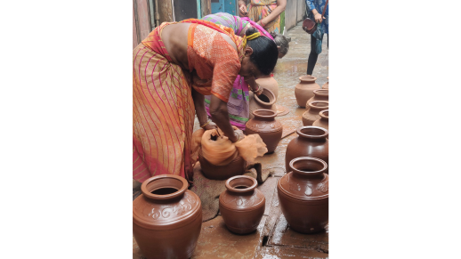 Woman polishing the pots after they have dried, getting them ready to be fired in the kilns.