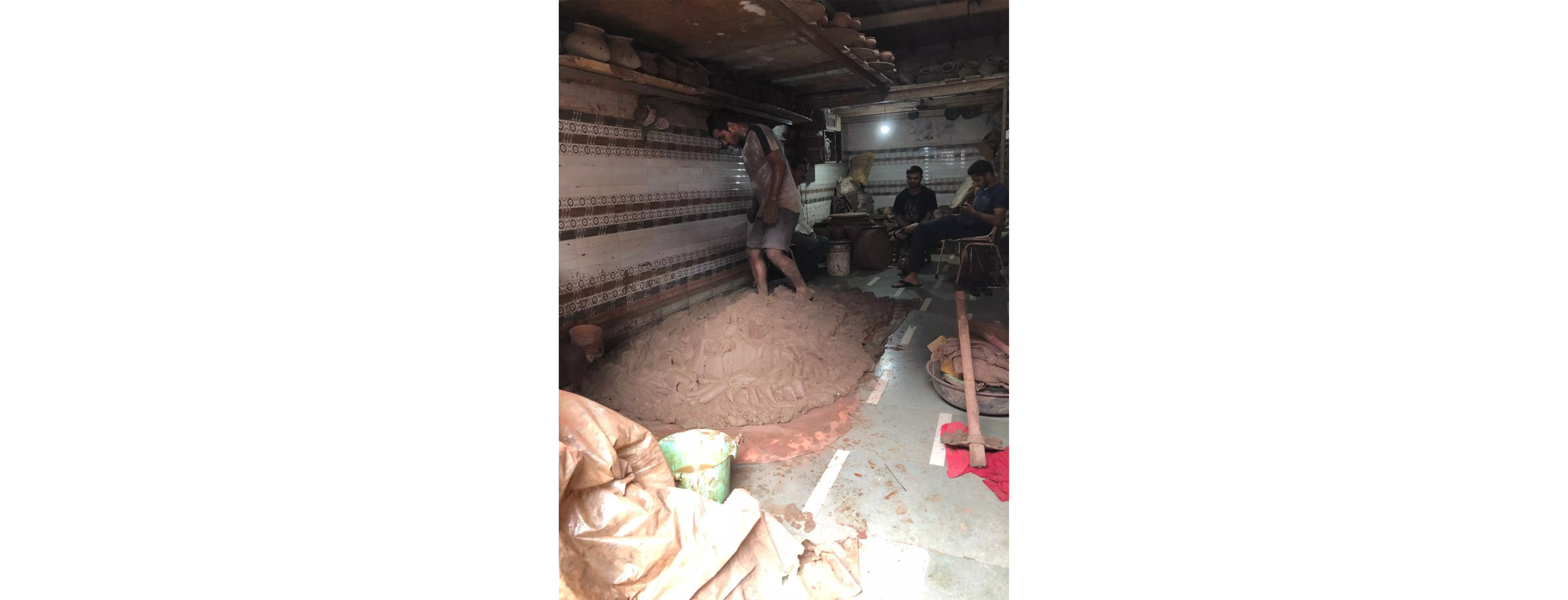 Stomping on the clay, to get it ready to be moulded.