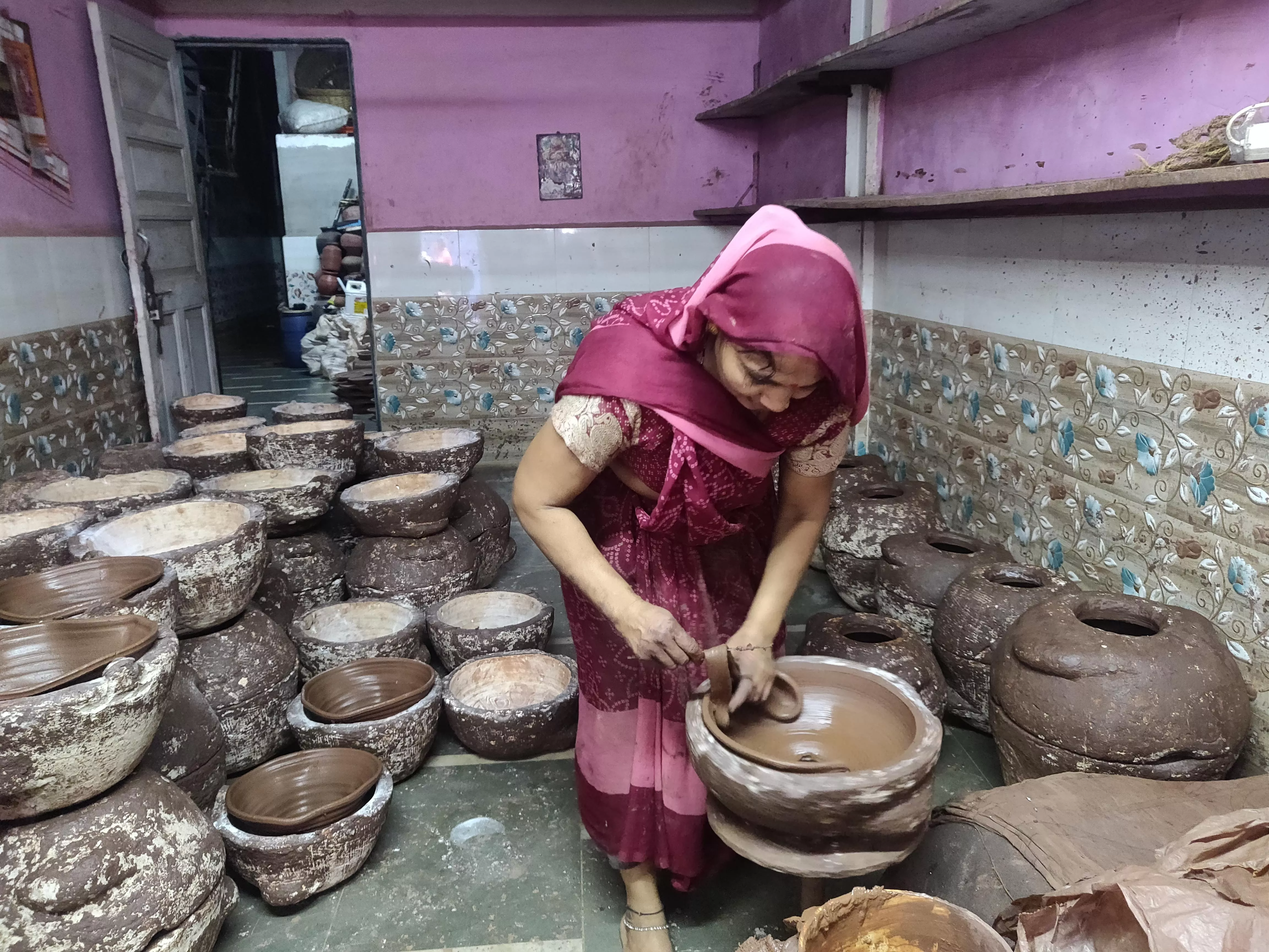 The pots are initially shaped on the wheel and subsequently refined in the moulds and left to dry.