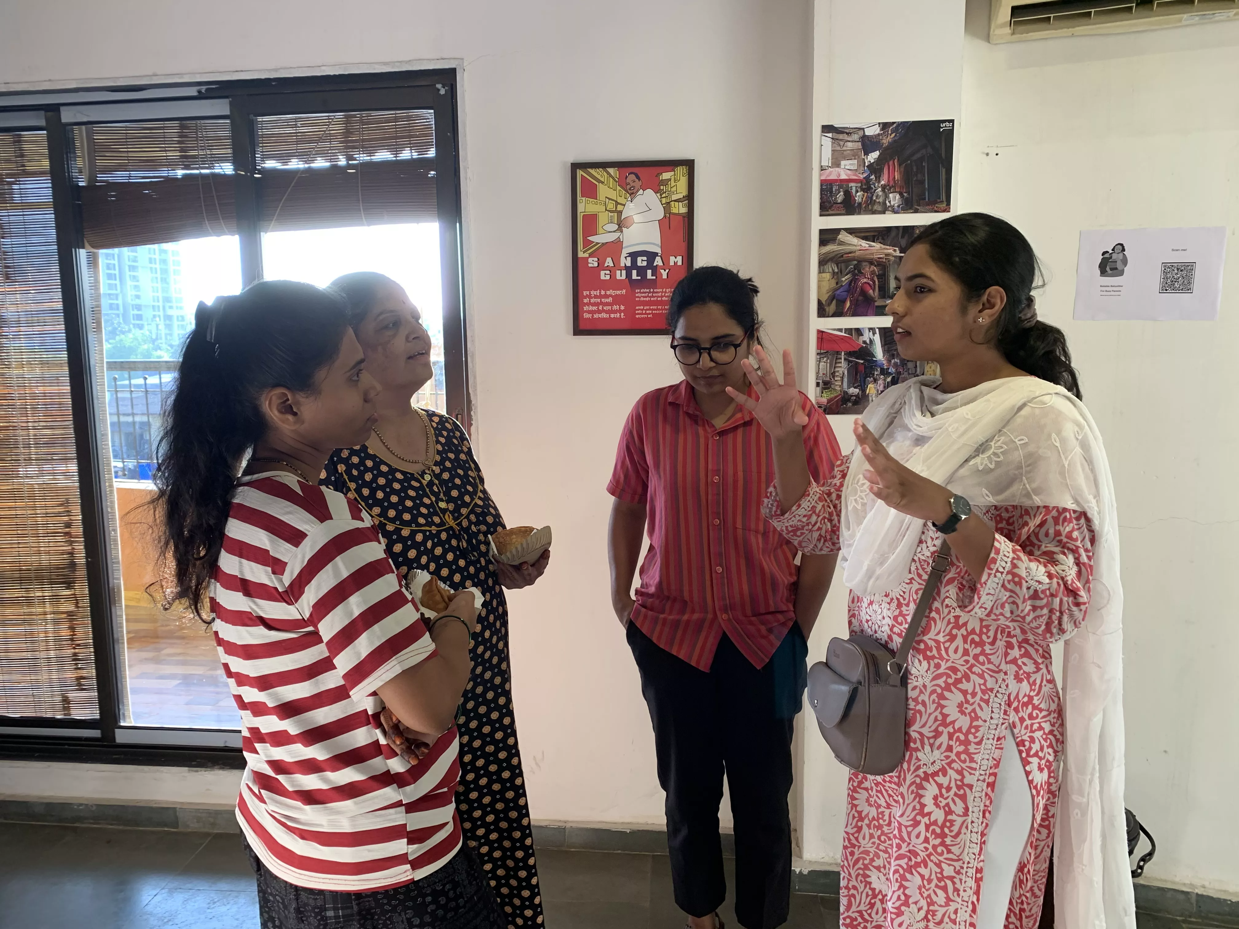   Samya Korde speaking with locals at the Homegrown street exhibition 