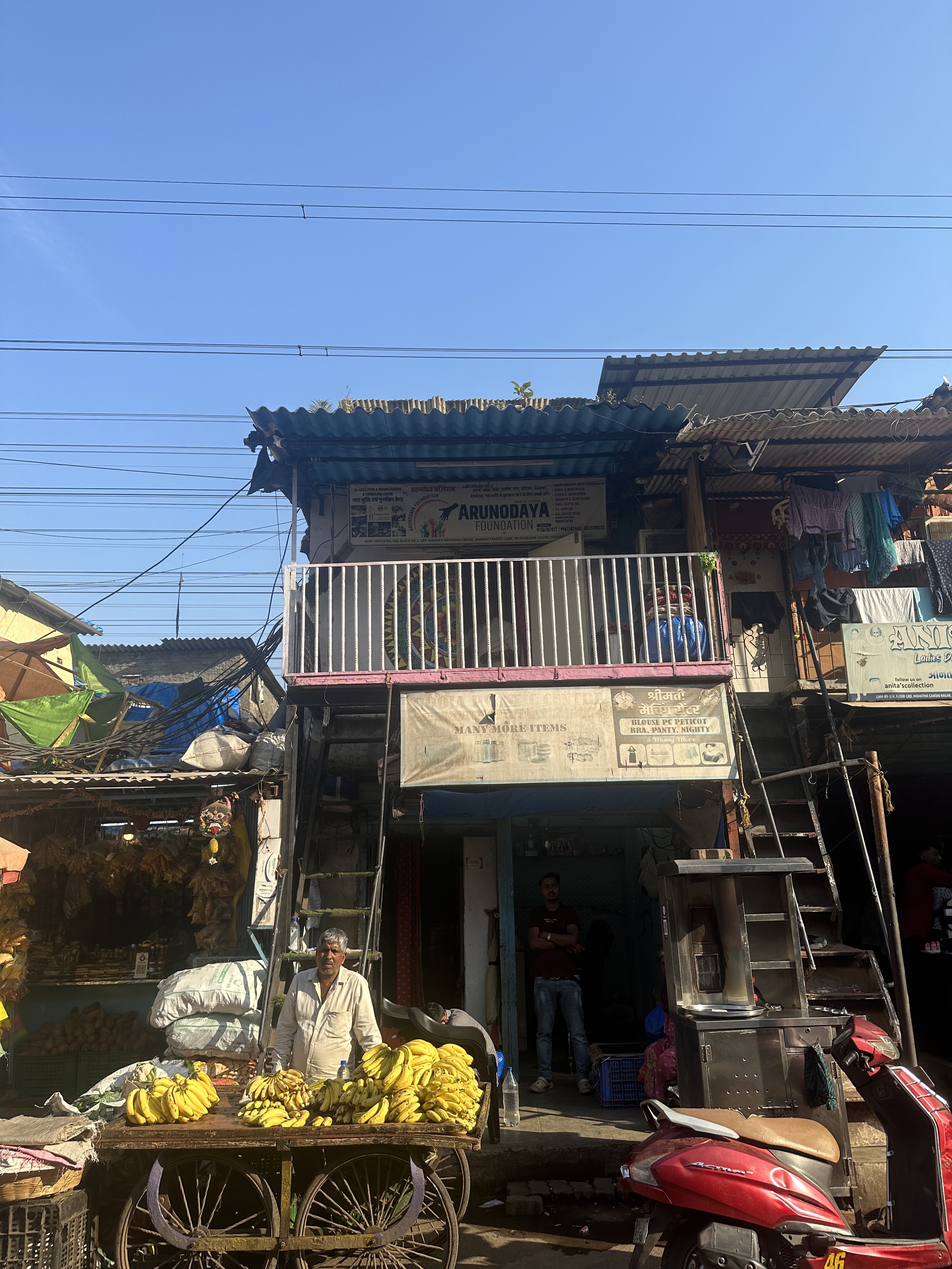 The NGO, Arunodaya, from outside. The banana seller downstairs. 