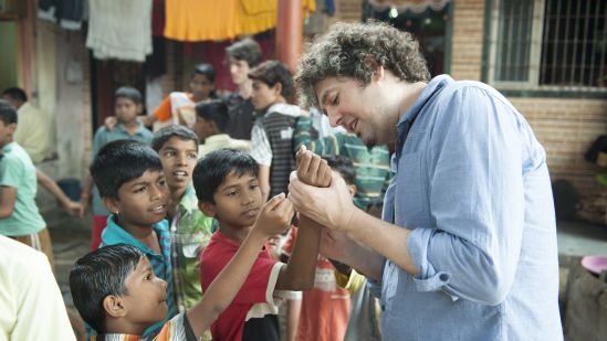 Luca Pattaroni (Professor at EPFL) reading palms to children in Bhandup.