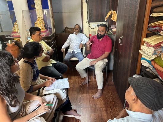 At Suryakant’s residence, in a building redeveloped by the SRA. Suryakant in the red shirt, Mohammed next to him.