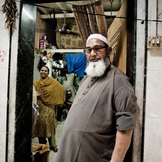 My home is not a slum: A friendly couple welcomes you to their home in Dharavi – otherwise misrepresented as the largest slum in Asia. (Photo by Brooks Reynolds for urbz).
