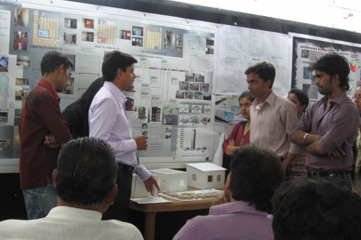 Contractor Pankaj Gupta discussing construction techniques with students.
