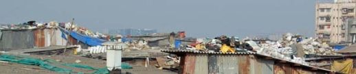 Thirteenth Compound is marked by huge quantities of goods stored on its roofs. Whereas everywhere in Dharavi roofs only serve as a protection against the fierce sun and the monsoon rains, the roofs in Thirteenth Compound are the warehouses for light weight goods. Primarily plastics.
