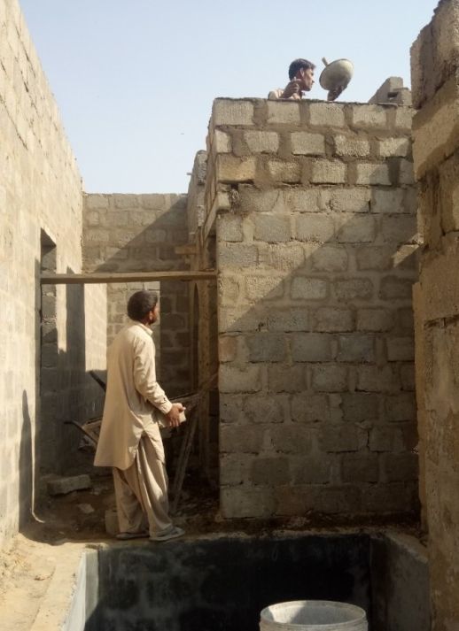 Load-bearing structure under construction in Orangi.