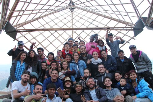 The entire team involved in the workshop with the structure installed in the background